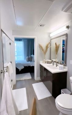 a bathroom with a toilet, sink, and shower in it's own room