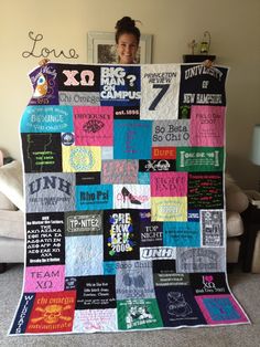 a woman standing in front of a quilt made to look like it has various t - shirts on it