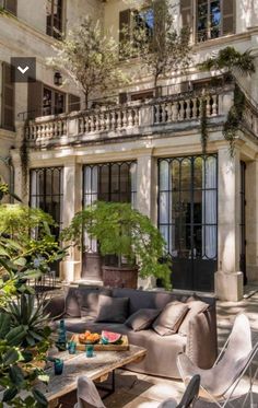 a living room filled with furniture next to a tall building