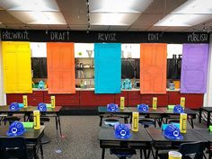 an empty classroom with colorful doors and desks