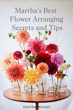 there are many vases with flowers in them on top of a table that says martha's best flower arranging secrets and tips