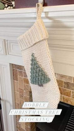 a knitted christmas stocking hanging from a fireplace with the words people christmas tree on it