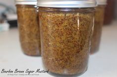 three jars filled with food sitting on top of a counter