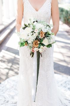 a bride holding her bouquet in front of the camera