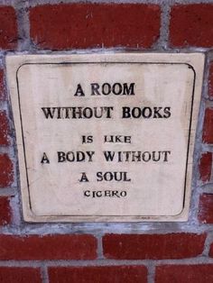 a room without books is like a body without a soul sign on a brick wall