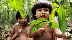 a man holding a baby in the forest