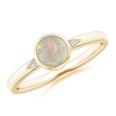 Bezel-set in 14k yellow gold is the round opal, displaying a scintillating play of color. It is flanked by glittering pavÃ©-set diamond accents, nestled within the cutout grooves. This solitaire opal ring is simple but stunning. Solitaire Opal Ring, Opal Solitaire Ring, Popular Rings, Ring With Diamond, Opal Ring, Bezel Diamond, Ring Size Guide, Opal Rings, Bezel Setting