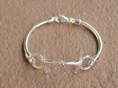 a silver bracelet with two cats on it