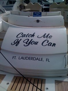 a sign that says catch me if you can on the back of a white boat