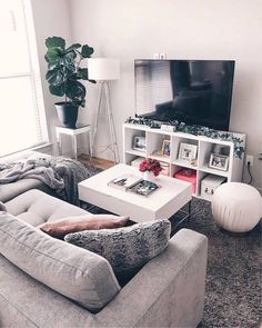 a living room filled with furniture and a flat screen tv on top of a wall