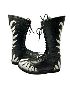 a pair of black and white boots with zebra print