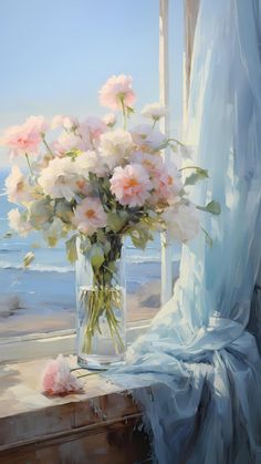 a vase filled with pink flowers sitting on top of a window sill next to a beach