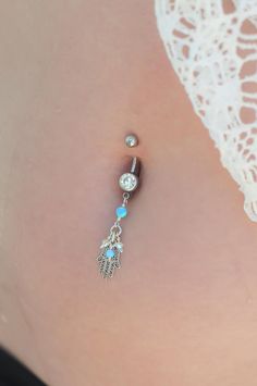 "A Hamsa belly button ring made with dangling light blue Opal stones and white Swarovski beads. This navel piercing is handmade of a Silver barbell, Hamsa hand pendant, and light blue Opal stones. The Hamsa (or Hand of Fatima) is a middle-eastern symbol of good luck, said to keep evil spirits away. Do not hesitate to contact me for special requests and customization! ♥♥ ▶ Sterling Silver curved barbell, 11 mm long for a universal fit. ▶ Delicate silver chain ▶ Light Blue Opal stones and white Sw Nickel Free Sterling Silver Dangle Belly Rings, Nickel-free Dangle Belly Rings In Sterling Silver, Nickel-free Sterling Silver Dangle Belly Rings, Adjustable Dangle Belly Rings As Gift, Nickel-free Dangle Belly Rings As Gift, Adjustable Blue Belly Rings As Gift, Dangle Body Jewelry With Charms As Gift, Nickel Free Dangle Belly Rings Gift, Sterling Silver Dangle Belly Rings For Gift