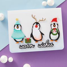 three penguins wearing christmas hats and sweaters with the words warm wishes written on them