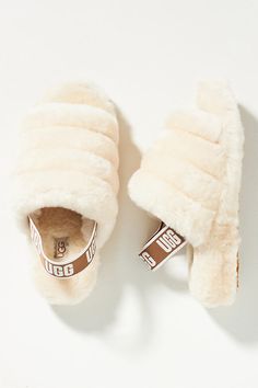 *Slip* into these fuzzy slides for ultimate cozy-comfort all season long — they pair perfectly with a set of printed pajamas or your favorite sweatpants. About UGG Founded in 1978 on the shores of sunny Southern California, UGG footwear quickly became a symbol of SoCal's relaxed surfer culture throughout the 1980s. Another decade later, and UGG's signature sheepskin styles were embraced by the fashion and celebrity worlds exactly how the company's young, Aussie-born founder envisioned it would h Fuzzy Slides, Ugg Tasman Slippers, Dr Shoes, Oprahs Favorite Things, Slide Slippers, Ugg Slippers, Birthday Wishlist