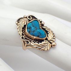 Native American Navajo artisan blossom design ring, made of 14k (.585) yellow gold with Turquoise stone centerpiece. Maker's initials - MC, probably by Michel Calladitto. This fabulous ring is a size 5 1/2, it is 28 mm at the widest, weighing 6.1 grams.  EA3952 Vintage Yellow Gold Turquoise Ring Hallmarked, Vintage Yellow Gold Turquoise Ring For Anniversary, Heirloom Hallmarked Yellow Gold Turquoise Ring, Antique Yellow Gold Turquoise Ring For Anniversary, Vintage Turquoise Ring In 14k Gold, Vintage 14k Gold Turquoise Ring, Vintage 14k Gold Turquoise Ring For Anniversary, Antique Untreated Turquoise Jewelry, Heirloom Gold Turquoise Gemstone Ring