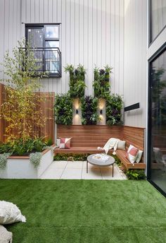 an outdoor seating area with grass and potted plants