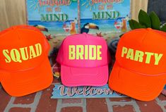 three hats with the words squad bride and party welcome are sitting on a brick floor