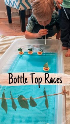 a young boy playing with a bottle top race