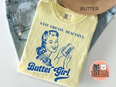 The Butter Girl retro-tshirt in a vintage style has the words "Easy Greasy Beautiful Butter Girl" and is the perfect funny baking retro foodie gift. This vintage meme, trendy shirt is printed on a Comfort Colors tee. Makes a great baker gift for your best friend, gift for mom or gift for her. 🎁 Thank you for shopping at WitAndWisecracks! We want to provide you with a delightful shopping experience, and we're here to assist you every step of the way. 🔍 Before you finalize your purchase, we reco Cooking Vintage, Funny Baking, Gifts For A Baker, Foodie Gifts, Dressed To Kill, Comfort Colors Tee, Trendy Shirts, Retro Shirts, Vintage Tee