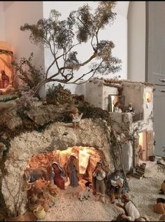 a nativity scene with figurines and trees