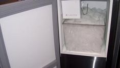 an open refrigerator with ice and water in it