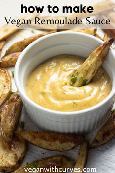 a white bowl filled with vegan remoulade sauce next to some fries