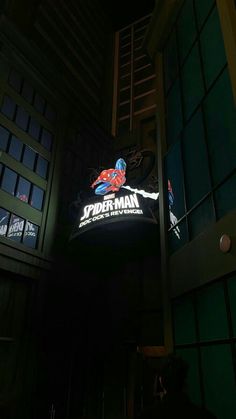 the spider man logo is lit up at night