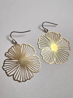 "Raw brass , BOHO style earrings. Great for everyday use. *Dimensions* 1.4\"x1.31\"x0.01\" 35.51mm x 33.16 mm x 0.34mm Weight: approximately 0.06oz  for a pair The jewelry comes with a silk pouch that you can store it. The pouch is made by embroidery silk fabric from India , up cycled from saris, colors various. If you have any problems after receiving the products, please feel free to contact me. I will give you a best solution. *Returns and exchanges * I gladly accept returns, exchanges, and cancellations. Just contact me within 3 days of delivery. Request a cancellation within 1 hour of purchase. *Conditions of return * Buyers are responsible for return shipping costs. If the item is not returned in its original condition, the buyer is responsible for any loss in value. Please contact m Silver Flower-shaped Brass Earrings, Metal Flower Earrings With Flower Charm, Gold Metal Earrings With Flower Charm, Brass Drop Earrings With Flower Charm, Gold Brass Flower-shaped Earrings, Gold Metal Drop Flower Earrings, Gold Metal Flower Drop Earrings, Nickel-free Gold Flower Shaped Earrings, Gold Metal Flower Shaped Earrings