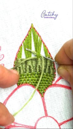 someone is stitching something on a piece of cloth