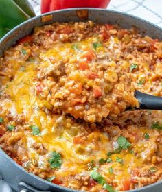 a skillet filled with mexican meat and cheese