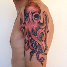 an octopus tattoo on the left arm and chest, with scissors in it's tentacles