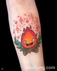 a tattoo with a fire and leaves on the arm, which is painted in red