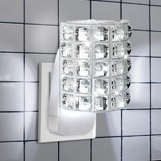 a light that is on the side of a wall in a room with tile walls