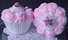 two cupcakes with pink frosting and roses on them