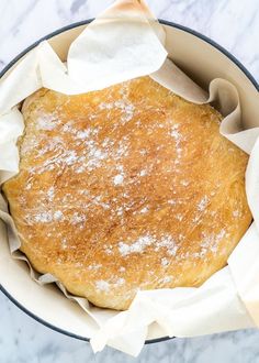 a pan filled with bread covered in powdered sugar