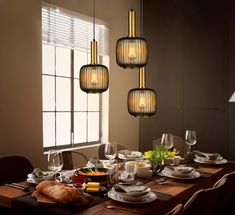 a dining room table is set with food and wine glasses