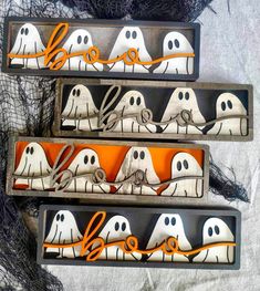 three wooden boxes with halloween decorations in them