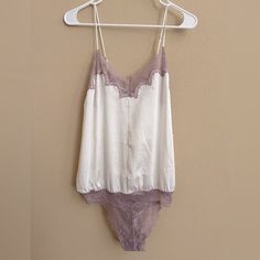 Nwot - Intimately Free People Bodysuit White Satin With Lavender Lace Trim “D8 Night” Style - Sold Out On Fp Adjustable Straps And Back Tie Hygienic Liner Intact New Without Tags White Elegant Camisole Bodysuit, Elegant White Camisole Bodysuit, Fitted White Bodysuit For Sleep, White Sleeveless Lined Camisole, White Lined Sleeveless Camisole, White Lined Bodysuit For Loungewear, White Lined Camisole, Free People Bodysuit, Bodysuit White