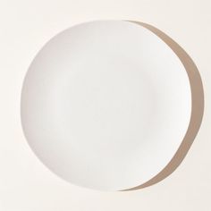 an empty white plate on a white surface