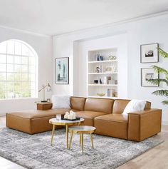 a living room filled with furniture and a large window