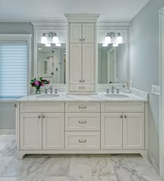 a large bathroom with double sinks and two mirrors