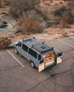 an suv parked in a parking lot with its doors open