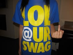 a girl in a blue and yellow t - shirt with the words out our swag on it