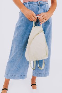 Carry all your essentials in style with the FREE PEOPLE - Soho Convertible Bag. This leather tote bag is the perfect versatile accessory for any outfit, giving you both practicality and fashion in one. Stay organized and effortlessly chic with this must-have bag. Casual Leather Backpack For On-the-go, Versatile Hobo Bag With Zipper Pocket For On-the-go, Versatile Everyday Hobo Bag With Zipper Pocket, Casual Hobo Bag With Removable Pouch For Everyday Use, Trendy Khaki Hobo Bag For Travel, Trendy Summer Shoulder Bag Backpack, Cream Hobo Bag With Zipper For Travel, Cream Hobo Bag For Travel With Zipper Closure, Spring Travel Khaki Shoulder Bag