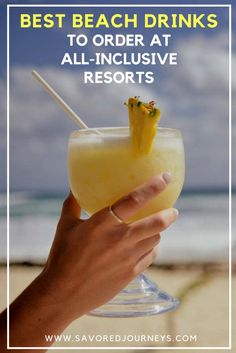 a hand holding a drink with the words best beach drinks to order at all - inclusive resort