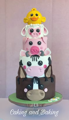 a three tiered cake with farm animals on it's sides and the words baking and baking written below