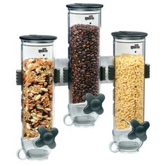 three glass containers filled with different types of cereals and nuts, one is hanging on the wall