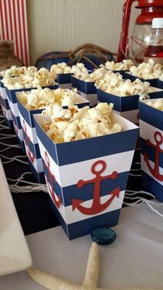 some popcorn in boxes with an anchor on them