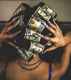 a woman covering her face with money